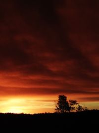 Silhouette of landscape against cloudy sky