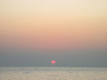 Scenic view of sea against sky at sunset