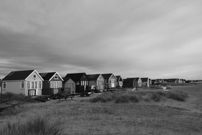 Houses on field against sky