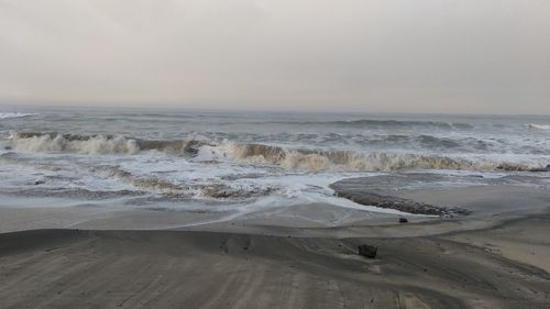 Scenic view of beach against sky during sunset