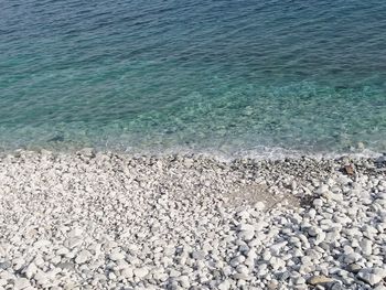 High angle view of pebbles on beach