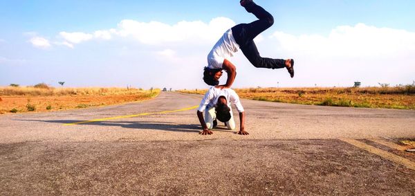 Full length of man and woman standing on road