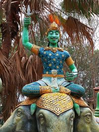 Statue of buddha against trees