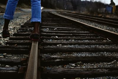 Low section view of person balancing on railroad track