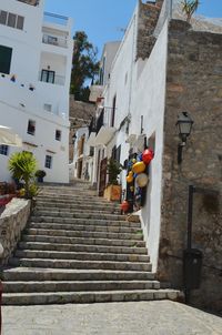 Low angle view of staircase amidst buildings in city