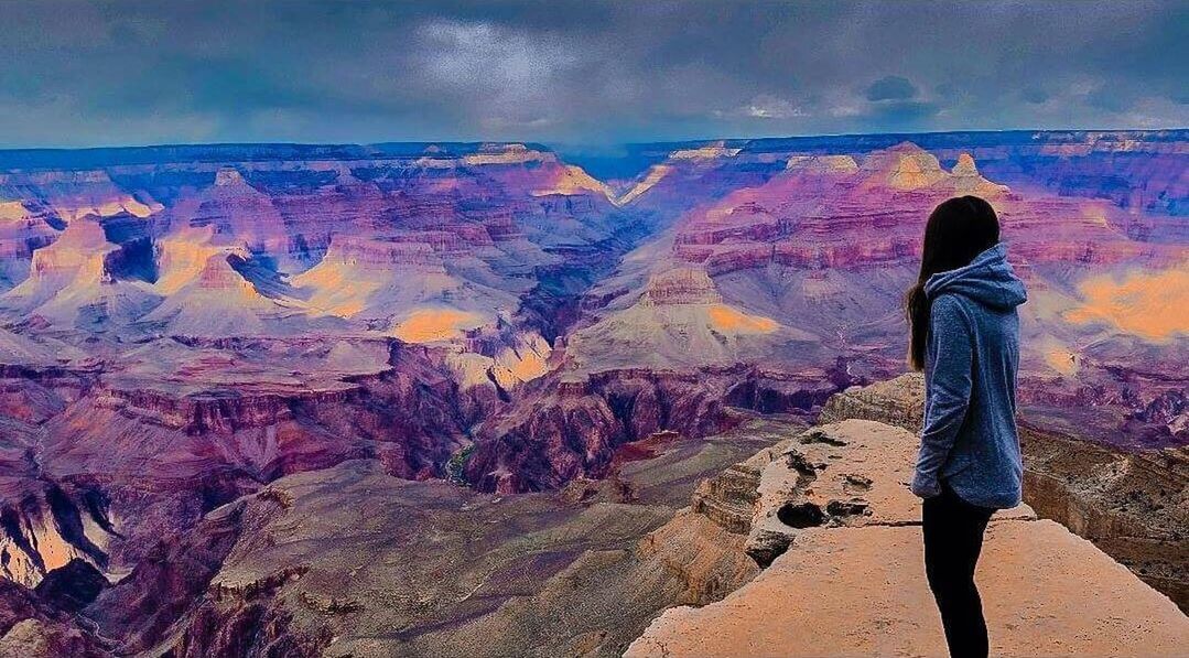 MAN STANDING ON ROCK