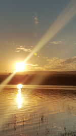 Scenic view of sea against sky at sunset