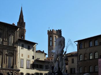 Low angle view of buildings against clear sky