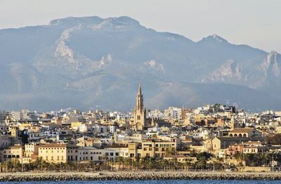 View of cityscape against majestic mountain