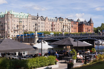 People in cafe by djurgardsbron in city