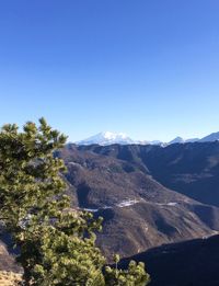 Scenic view of mountains against clear blue sky