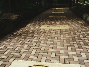 Narrow pathway along cobblestone street