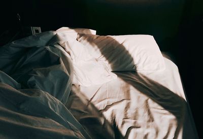 High angle view of messy bed at home