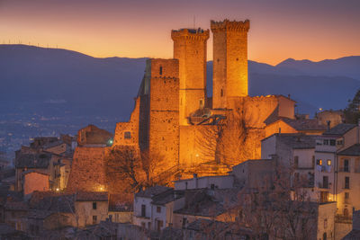 Old buildings in city during sunset