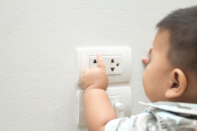 Boy touching electric outlet