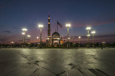 Illuminated street lights outside mosque at night