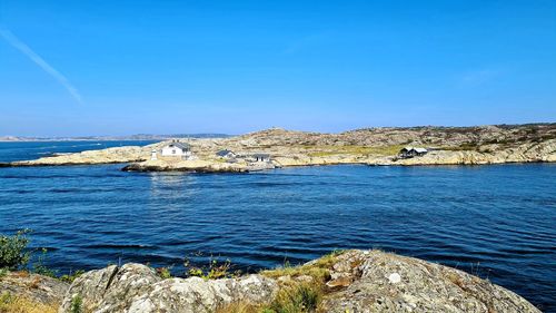 Scenic view of sea against clear blue sky