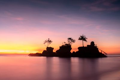 Scenic view of sea against romantic sky at sunset