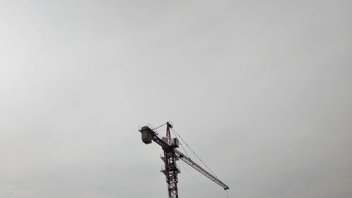 Low angle view of telephone pole against sky