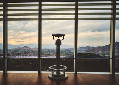 Cityscape seen through glass window against sky