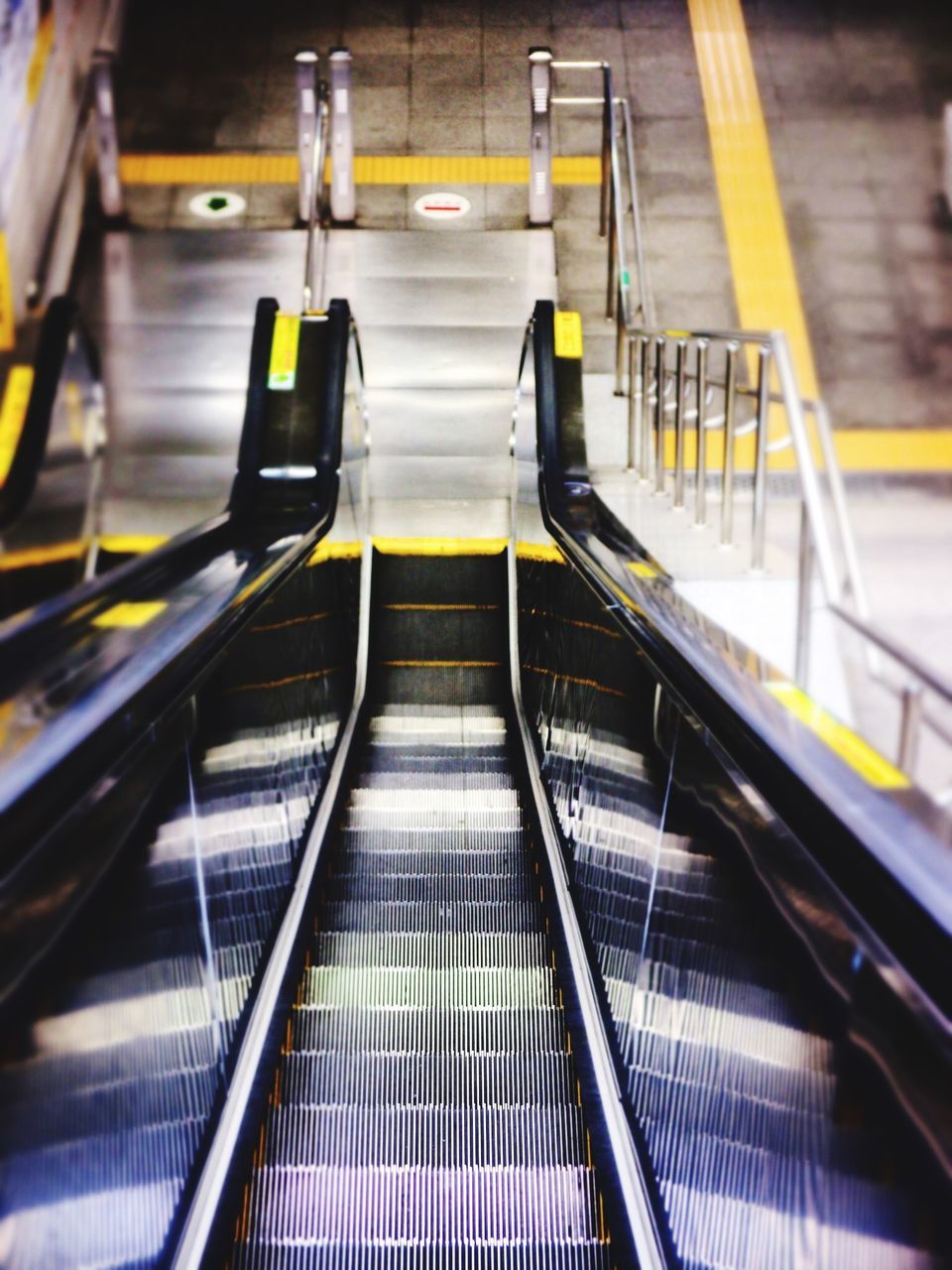 escalator, indoors, transportation, steps, steps and staircases, staircase, high angle view, railing, illuminated, public transportation, rail transportation, modern, convenience, the way forward, subway station, on the move, railroad station, mode of transport, technology, travel