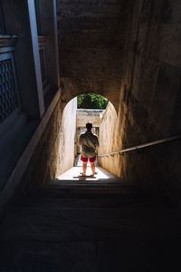 High angle view of man standing in tunnel