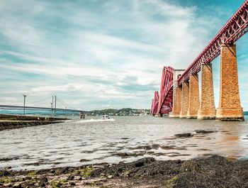 Low angle view of suspension bridge over river