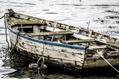 Abandoned boat moored in water