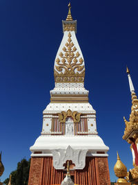 Low angle view of temple against clear blue sky