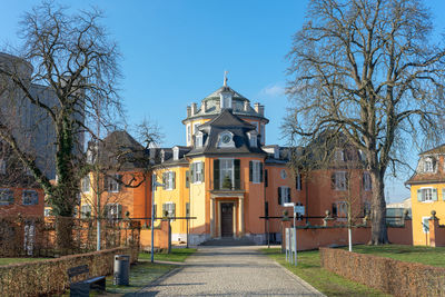 Footpath amidst buildings against sky