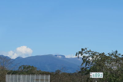 Scenic view of mountains against blue sky