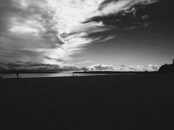View of beach against cloudy sky