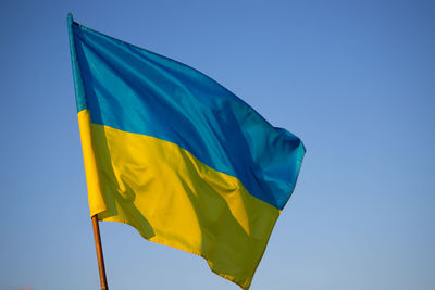 Low angle view of flag against clear sky