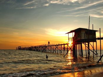 Silhouette of pier at sunset