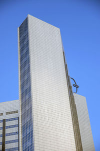 Low angle view of modern buildings against clear blue sky