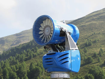 Traditional windmill on landscape against sky