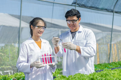 Scientists doing experiment in greenhouse