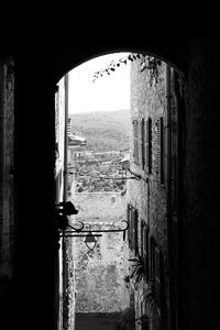 Buildings seen through window of old house