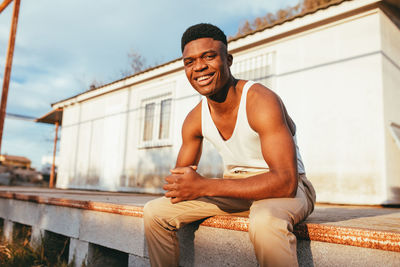 Portrait of young man sitting outdoors