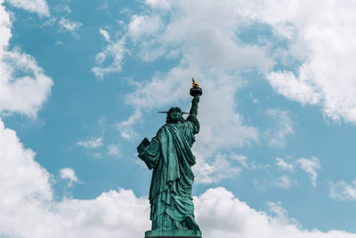 Low angle view of statue of liberty against sky