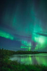 Scenic view of lake against sky at night