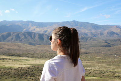 Rear view of woman looking at mountains