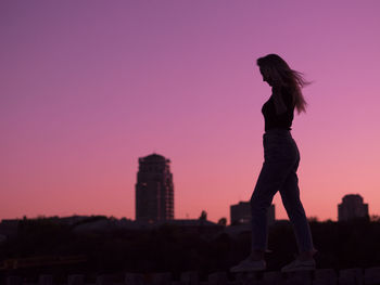 Silhouette of man against clear sky at sunset