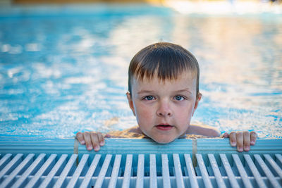 Portrait of cute boy in swimming pool