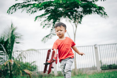 Portrait of boy against plants