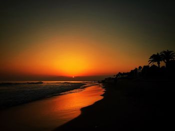 View of calm beach at sunset