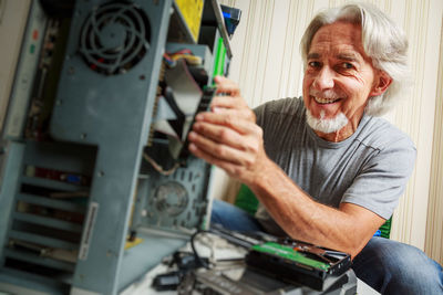 Portrait of smiling man sitting at home