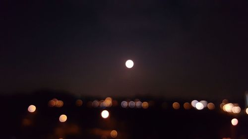 Illuminated lights against sky at night