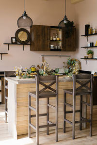 Wooden bar counter with wooden chairs in the interior of the kitchen dining room