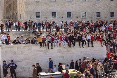 High angle view of people standing outside historic building